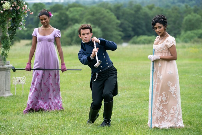 BRIDGERTON_203_Unit_01664R Playing Pall-Mall in Bridgerton (L to R) Simone Ashley as Kate Sharma, Jonathan Bailey as Anthony Bridgerton, Charithra Chandran as Edwina Sharma in an episode of Bridgerton. (Imagee by Liam Daniel/Netflix © 2022)