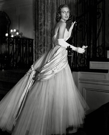 Vogue 1949 Chicago debutante Joan Peterkin in strapless, tulle and white satin Dior dress, with white gloves. (Photo by Horst P. Horst/Condé Nast via Getty Images)