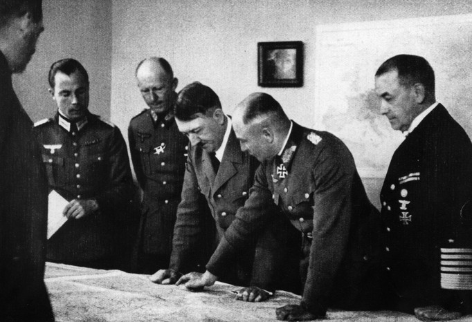 Adolf Hitler at his headquarters at Bruly-de-Peche, Ardennes, Belgium, during the campaign of May-June 1940. Left of Hitler is General Alfred Jodl, and on the right is Field Marshal Walther von Brauchitsch, commander-in-chief of the German army. Next to him is Admiral of the Fleet Dr Erich Raeder. (Photo by Hulton Archive/Getty Images) Adolf Hitler at his headquarters at Bruly-de-Peche, Ardennes, Belgium, 1940