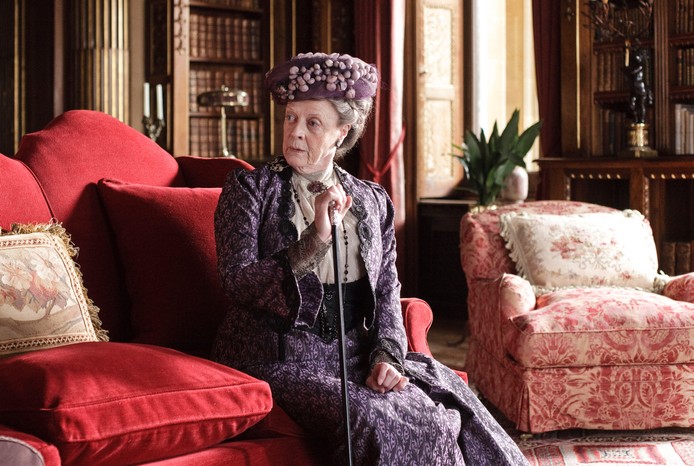 Maggie Smith as the Dowager Lady Grantham in Downton Abbey Actor Maggie Smith in a purple Edwardian gown,, as Dowager Lady Grantham